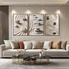 A living room in beige, brown, and terracotta tones. Above the sofa, three Zen Garden Prints in light frames enhance the Japandi aesthetic. The earthy hues and natural elements create a calming and harmonious atmosphere.