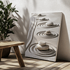 This Zen Garden Print features stacked pebbles on raked sand with concentric circles. It is displayed on a sunlit floor near a leafy plant and wooden bench, creating a calm and harmonious ambiance.