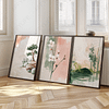Three framed prints from a Japandi Wall Art Set lean against a sunlit wall by a window. They depict a bonsai, cherry blossoms, and bamboo, evoking tranquility and elegance.