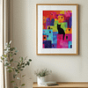 A framed Colorful Cat Art painting of a black cat sitting on colorful abstract rooftops. Displayed in a minimalist room with a wooden side table, a potted plant, and beige curtains, adding an artistic touch.