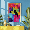 This is a framed Colorful Cat Art print featuring a black cat sitting against a background of colorful abstract buildings. Sunlight streams in, casting dynamic shadows on the blue wall.