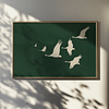 Framed Japandi Wall Art depicting white cranes in flight against a dark green background. Soft shadows and natural light enhance the serene and elegant atmosphere.