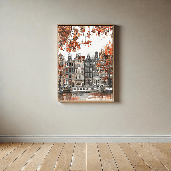 Amsterdam autumn art print in a minimalist room with light beige walls and wooden flooring. The artwork depicts Amsterdam’s iconic canal houses with warm autumn leaves in red, brown, and orange tones. The simple, neutral room enhances the warm colors of the print.