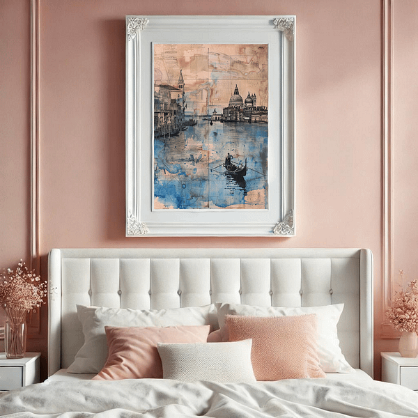 A Venice digital art in a white, ornate frame hung on a pastel pink wall above a white tufted bed with soft pillows. The romantic setting complements the artwork's calming blue and tan tones.