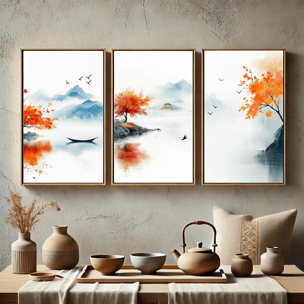 This minimalist dining room features three framed Japandi autumn decor prints. The calming autumn colors of orange, blue, and gray blend with the wooden table, pottery, and tea set in a natural, peaceful setting.