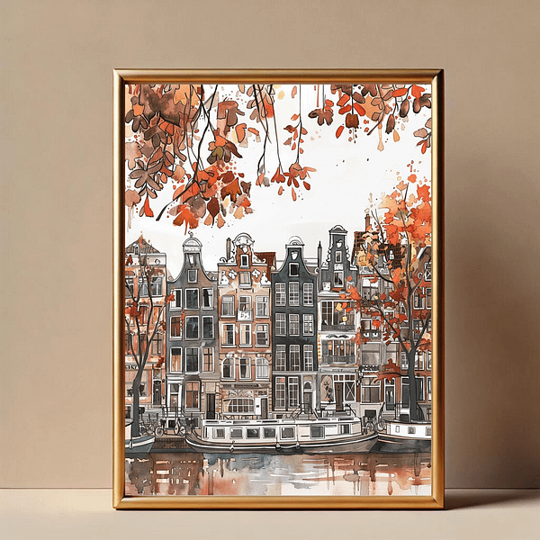 Amsterdam autumn art print in a sleek, gold-framed picture. The artwork, featuring Amsterdam’s canal houses surrounded by autumn leaves, stands out against the simple beige wall, adding a touch of warmth to the room.