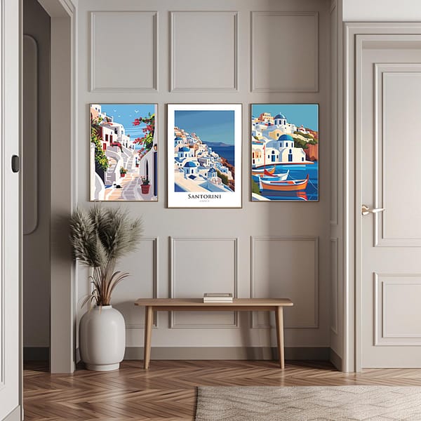 Three framed Santorini travel posters in a hallway with a minimalist decor. The posters showcase the island's blue-domed churches, serene streets, and colorful boats, adding a Mediterranean touch to the neutral-toned space.