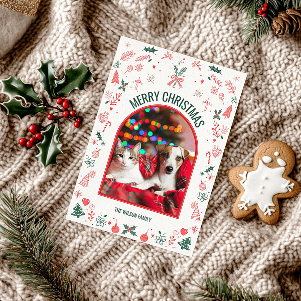 This customizable Christmas Card features the front page on a knitted scarf, accompanied by a gingerbread cookie and pine branches for a cozy holiday feel.